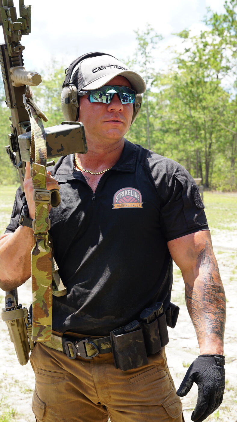 Shooter with rifle at an outdoor range